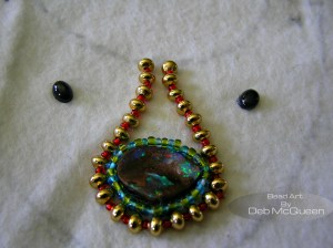 G.P. saucer beads placed on their sides, with red seedbeads between each saucer bead