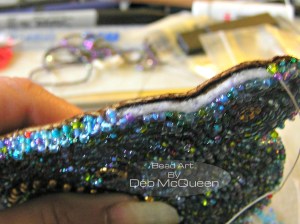 edging, 3 beads at a time  going through felt, aida cloth and 3/4 of the way through the leather